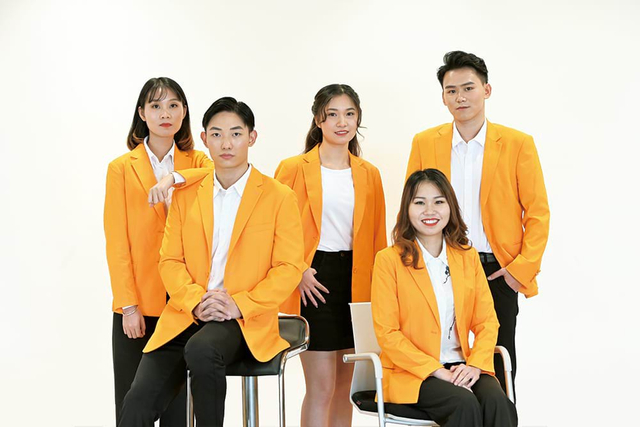 Professional sales team in corporate yellow blazers