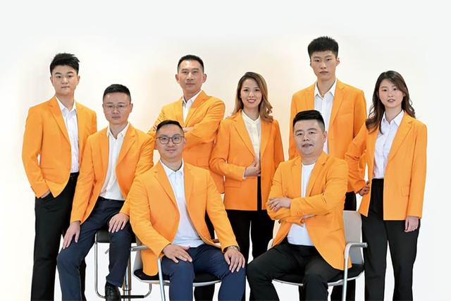 Senior management team in signature yellow uniforms