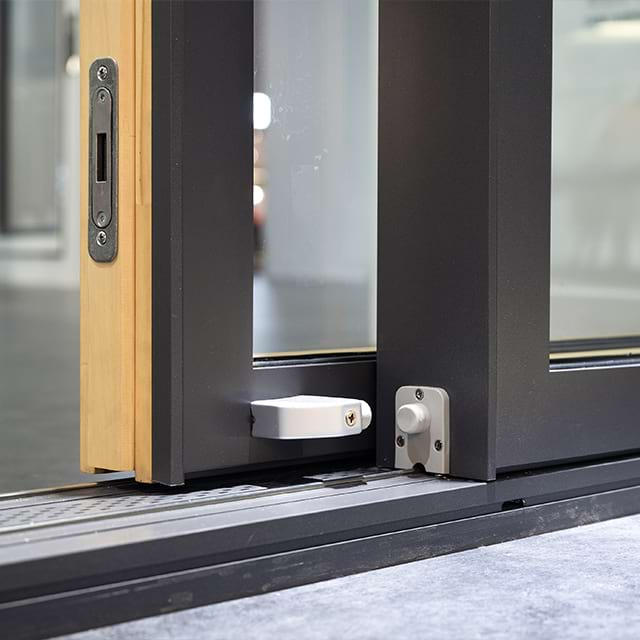 Aluminum clad sliding door lock mechanism