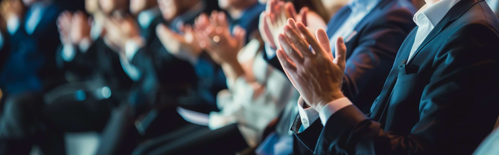 Professional audience applauding at industry conference